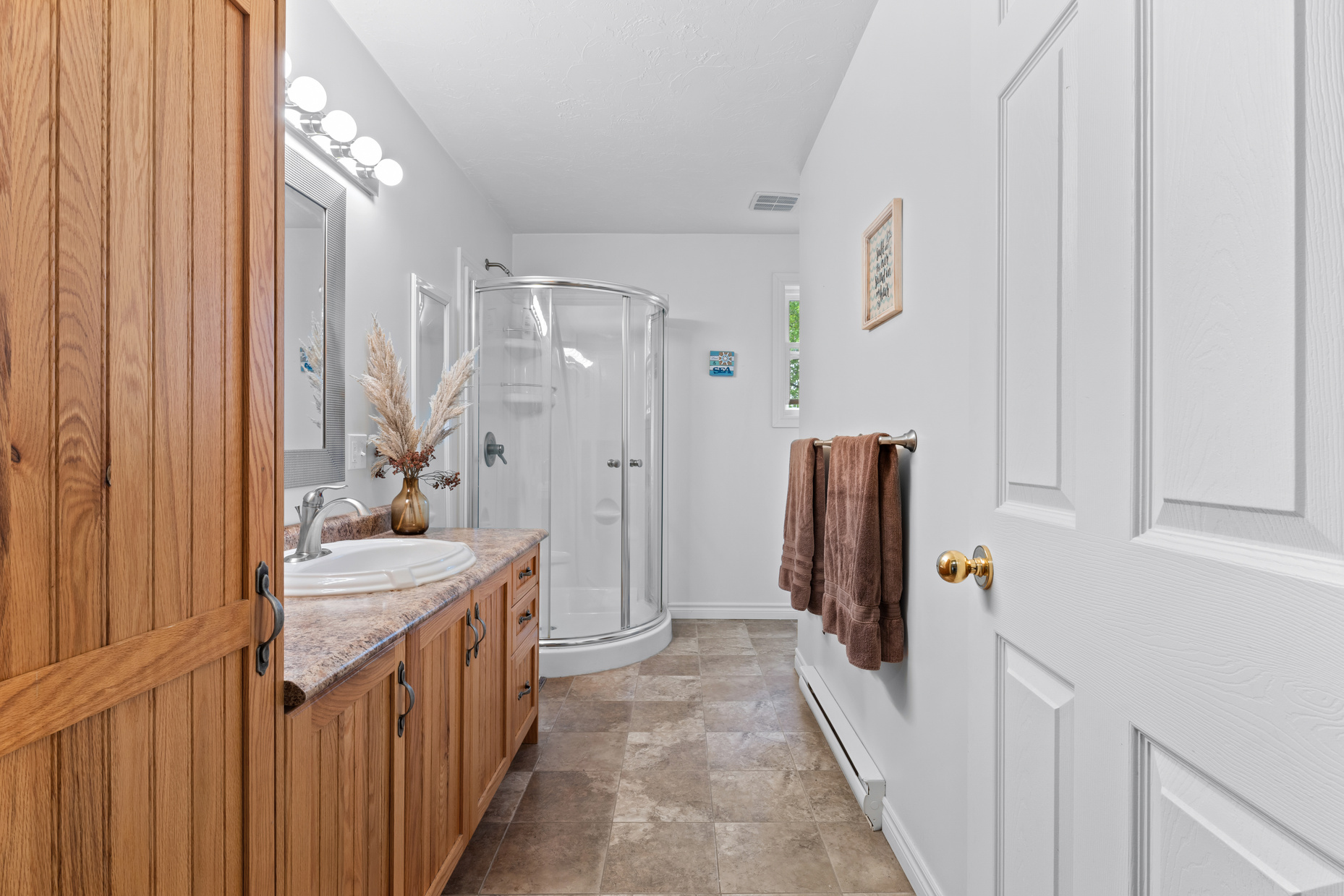 Loft bathroom with vanity and glass shower